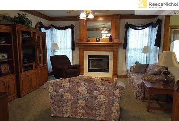 Very spacious Great Room, Crown Molding, ceiling fan, corner windows. Open Window to Kitchen.