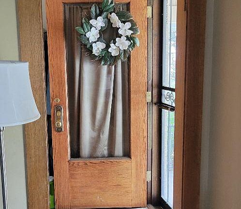 Front door and foyer with space behind the door to hang coats