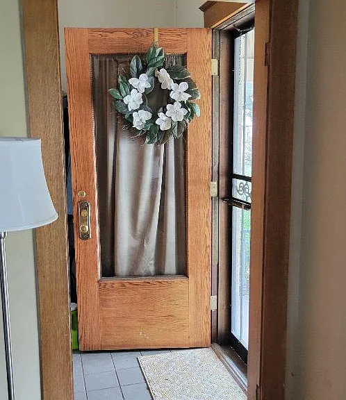 Front door and foyer with space behind the door to hang coats