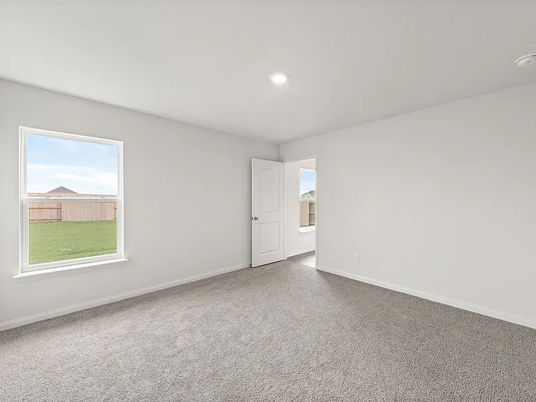 The master bedroom has a large window.