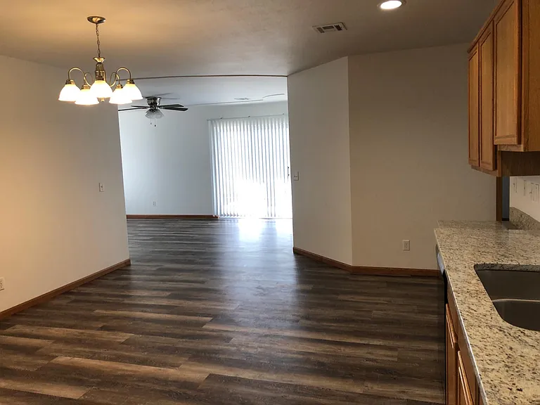 Living room from kitchen area perspective showing dining area as well