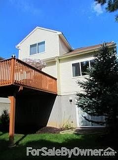 Rear Right : Full basement with patio door entrance.