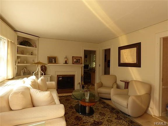 Bright, sunny living room with fireplace