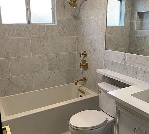 Brand new bathroom with Carrera Marble and Brushed Brass Fixtures. A spa like bath to be enjoyed.