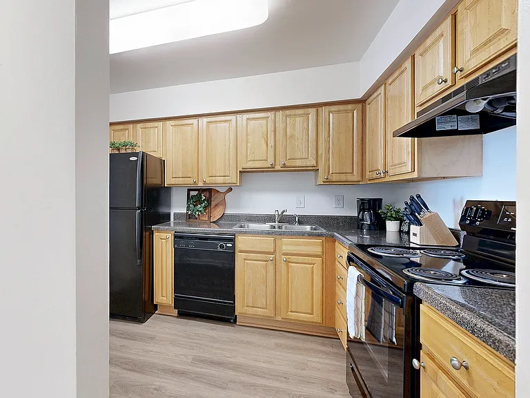 Kitchen with granite counters and black appliance package