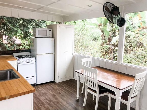 Another view of the kitchen with the hidden stacked washer/dryer on the open air lanai
