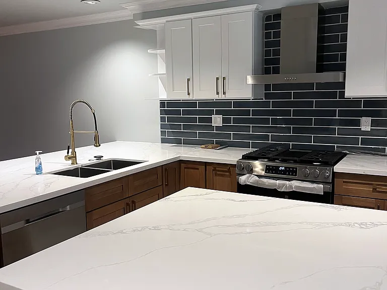 New White Oak kitchen with large quartz countertops and stainless steel appliances