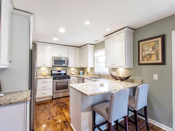 Modern eat in Kitchen with granite, new appliances and generous storage including pantry.
