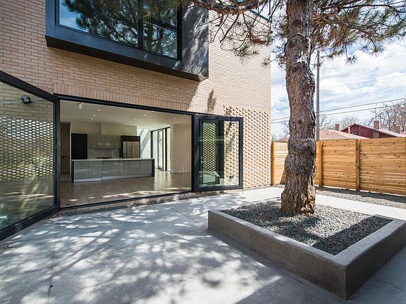 Indoor/outdoor living with private enclosed courtyard. Large steel and glass door as well as separate man-door for everyday entry/exit.