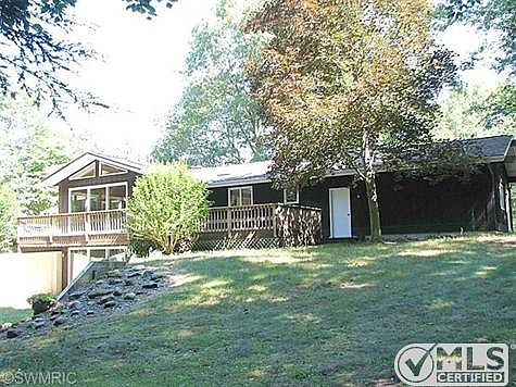 View of the huge back yard observation deck that goes across the entire back of the home.  There is a private back yard deck off the master that would be perfect for a hot tub!