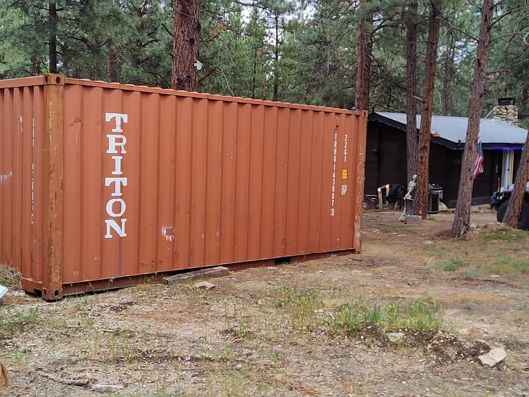 8 ft. X 20 ft. Watertight shipping container included. Leveled and facing cabin.