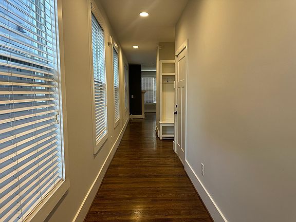 Entryway with custom drop zone off garage entry & security system at entry