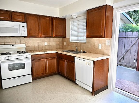 Spacious kitchen with built-ins, breakfast nook, and patio