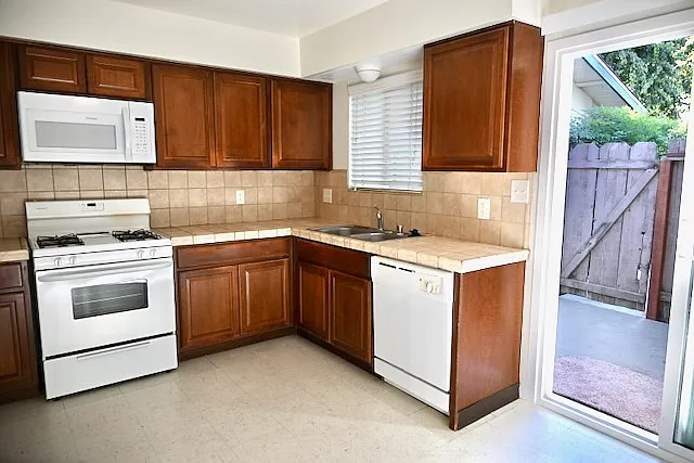 Spacious kitchen with built-ins, breakfast nook, and patio