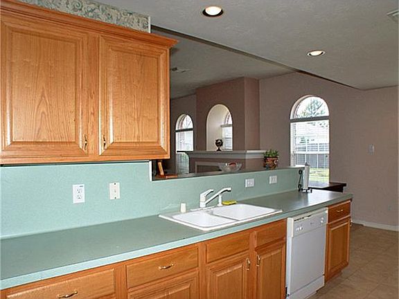 BEAUTIFUL OAK CABINETS, SUBTLE COLORS, OPEN TO DEN AND BREAKFAST AREA