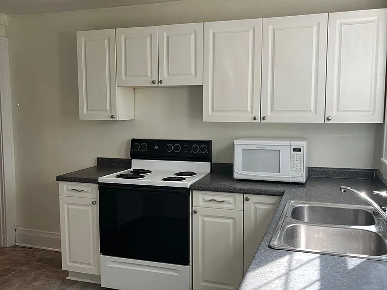 Ample cabinet space in kitchen , freshly painted