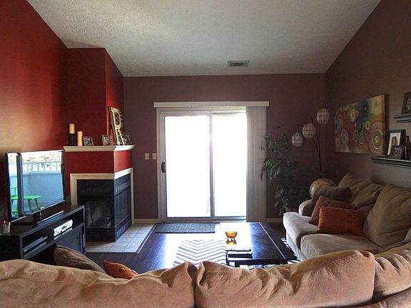 Open living room with wood burning fireplace.
