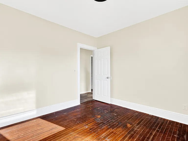 Bedroom with hardwood floors.