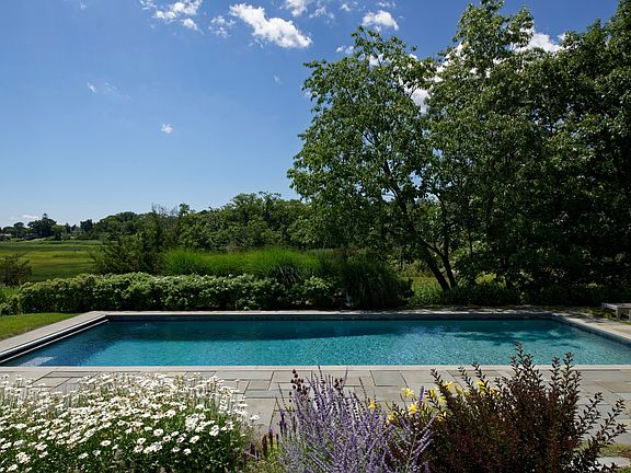 Beautiful heated gunite pool with lap lane, underwater lights and bench. Enjoy the south facing year round hot tub and dual heated showers after a swim.
