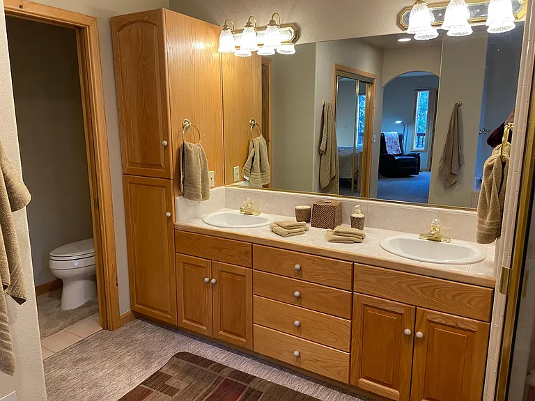 Mater bath on the first floor with two sinks and separate toilet room with fan