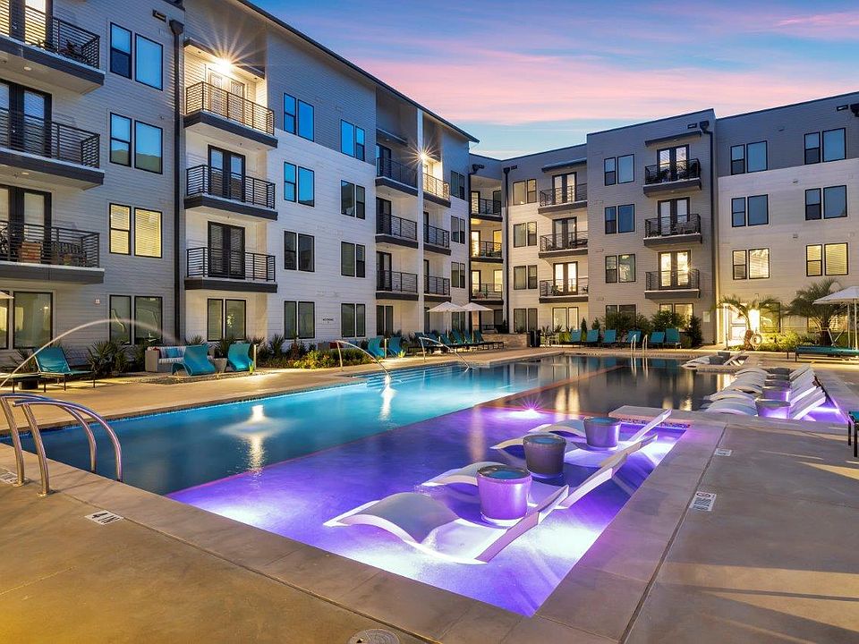 Nexus East Outdoor Pool with Lights and Lounge Chairs