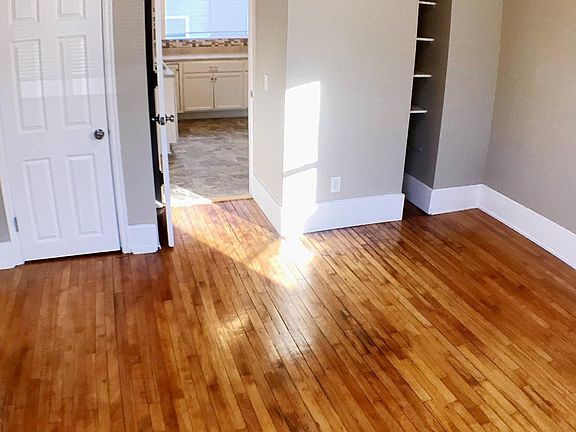 Another sunny bedroom with closet and shelves