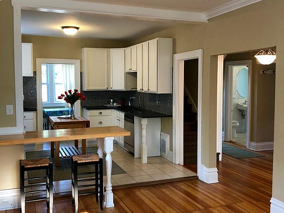 Kitchen with counter stools, granite, SS appliances
