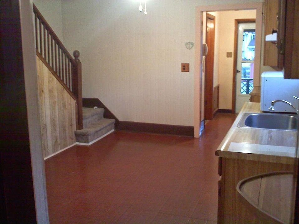 kitchen has a working electric stove and refrigerator