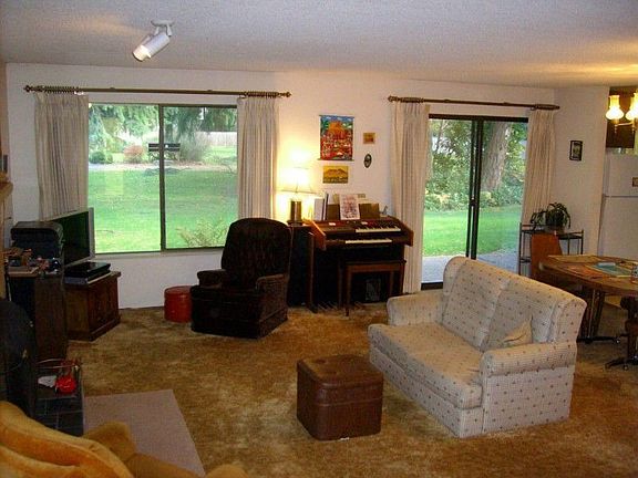 Windows galore let light flood this giant living room, which flows nicely to the dining room area.