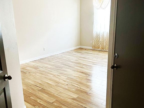 From the front door, the hallway comes to this area. The door on the right that leads to the garage. The door on the left is a coat closet.