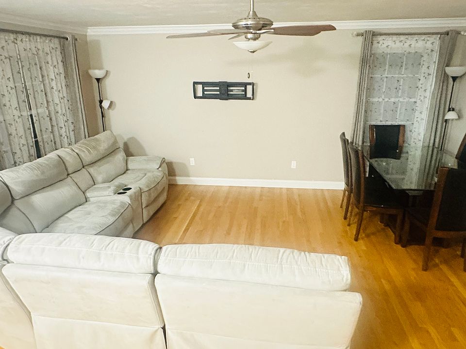 Living Room with sectional sofa, TV wall mount and dining table