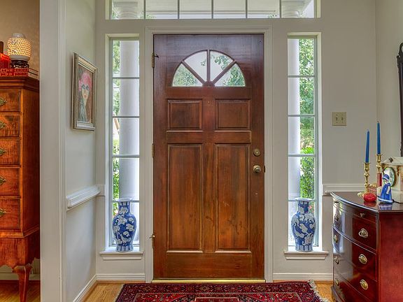 Beautiful Entry with Transom and Side Lights Inviting Natural Light into the Space