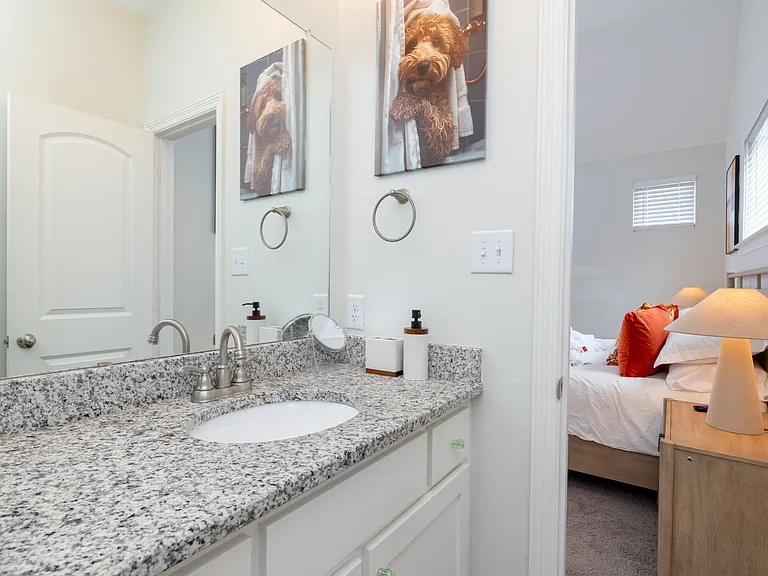Bathroom 1 features a tub/shower combo, granite countertop with sink, and a sleek mirror_offering both comfort and style.