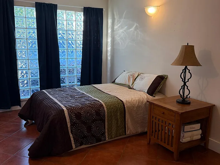 Furnished with full size bed, bedside table and lamp