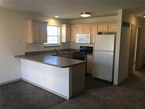 Kitchen includes refrigerator, electric stove, microwave & dishwasher.