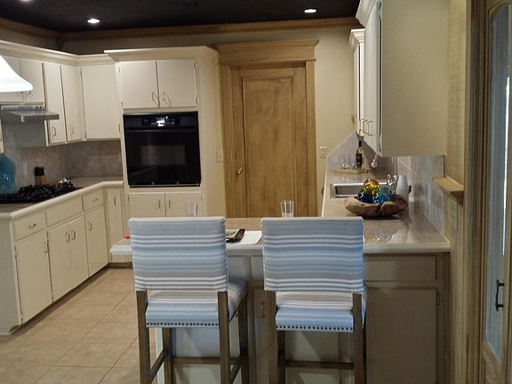 Lots of cabinets in kitchen, grantie tiled countertops, open