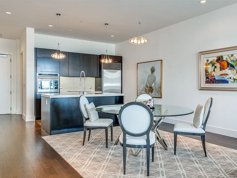 Dining space with recessed lighting, dark wood-style floors, and a chandelier