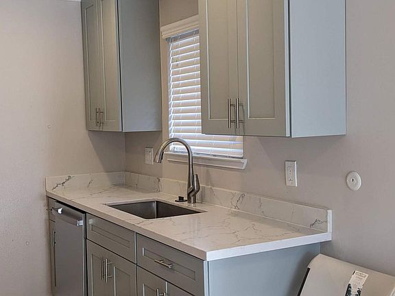 New cabinet with quartz counter top, dish washer, sink and faucet