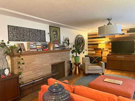 Living Room - a large room with a working fireplace and piano. Comfy sofa and chairs.