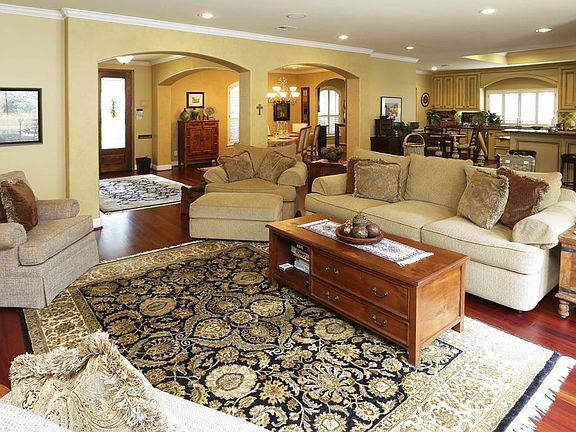 Open and spacious den with beautiful hardwood floors, gas log fireplace with custom mantle, many bui