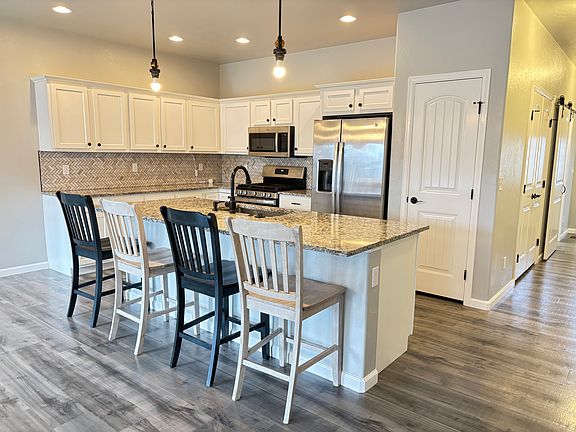 The kitchen has a stainless gas stove, microwave, refrigerator, DW and 2 pantries. The chairs at the counter come with the rental.