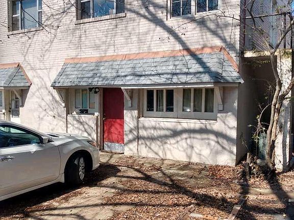 Rear of the building. Entrance to 521 B's kitchen door off of the parking lot. New door is sealed wood, not red.