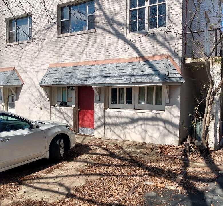 Rear of the building. Entrance to 521 B's kitchen door off of the parking lot. New door is sealed wood, not red.