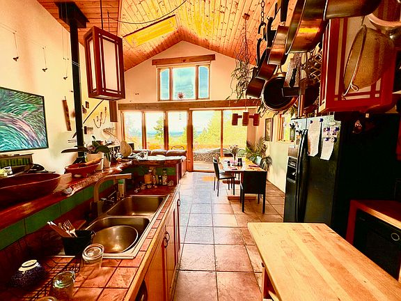 View of Great Room from Kitchen with overhead pot and utensil rack.