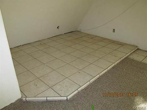 Tiled platform in living room alcove.
