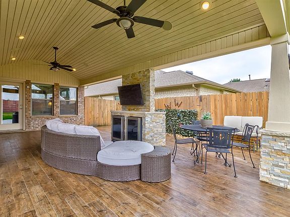 Extended covered patio included built-in speakers and fans to keep you cool while cooking out and enjoying the game while your kids play in the enormous back yard.