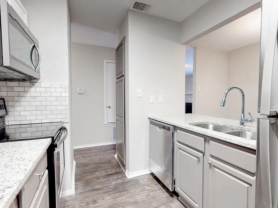 Kitchen with all new stainless steel appliances, granite countertop, marble backsplash, brush nickel/chrome hardware in selected units