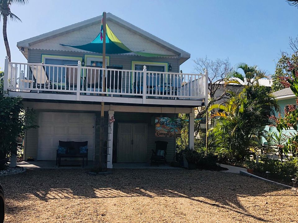Lazy Limpkin Cottage. One driveway space provided for off street parking. Balmy Breeze Bungalow is on the rightside downstairs.