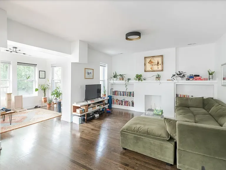 Spacious living room with attached sunroom and den