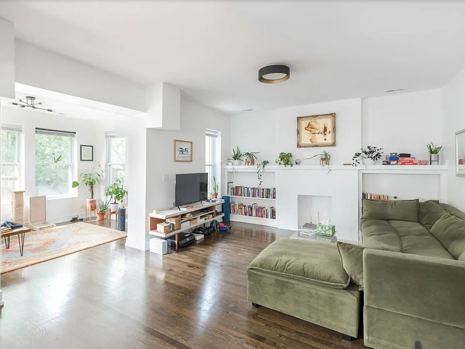 Spacious living room with attached sunroom and den